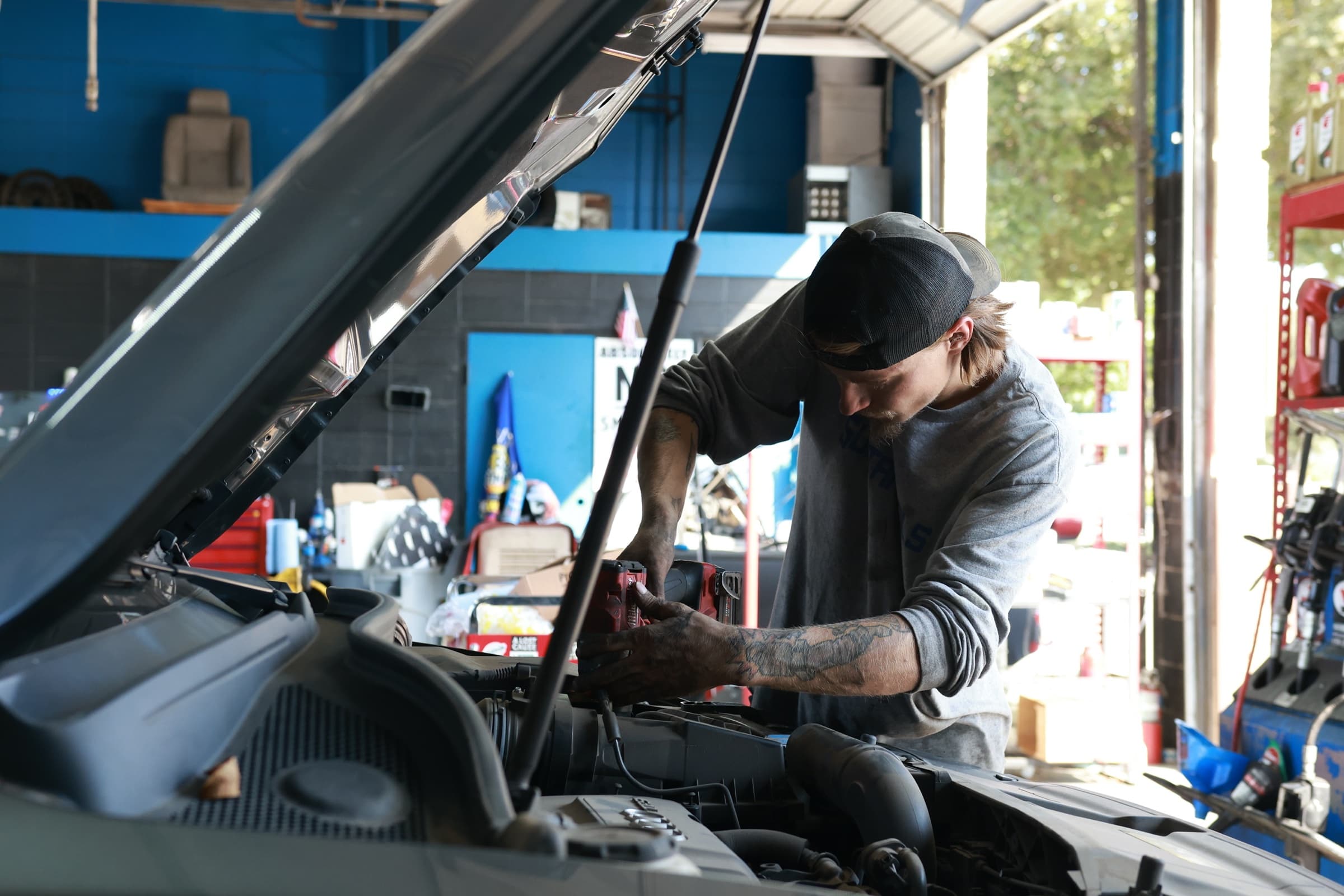 Technician working under the hood at Patriot Auto Repair in Addison
